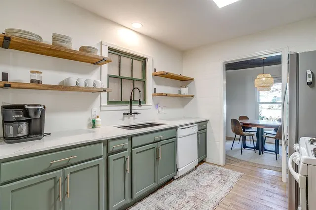 a spacious bathroom with a granite countertop sink a toilet and a mirror