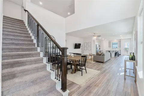 a view of a hallway with wooden floor and staircase