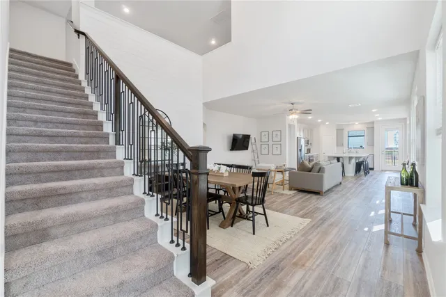 a view of a hallway with wooden floor and staircase