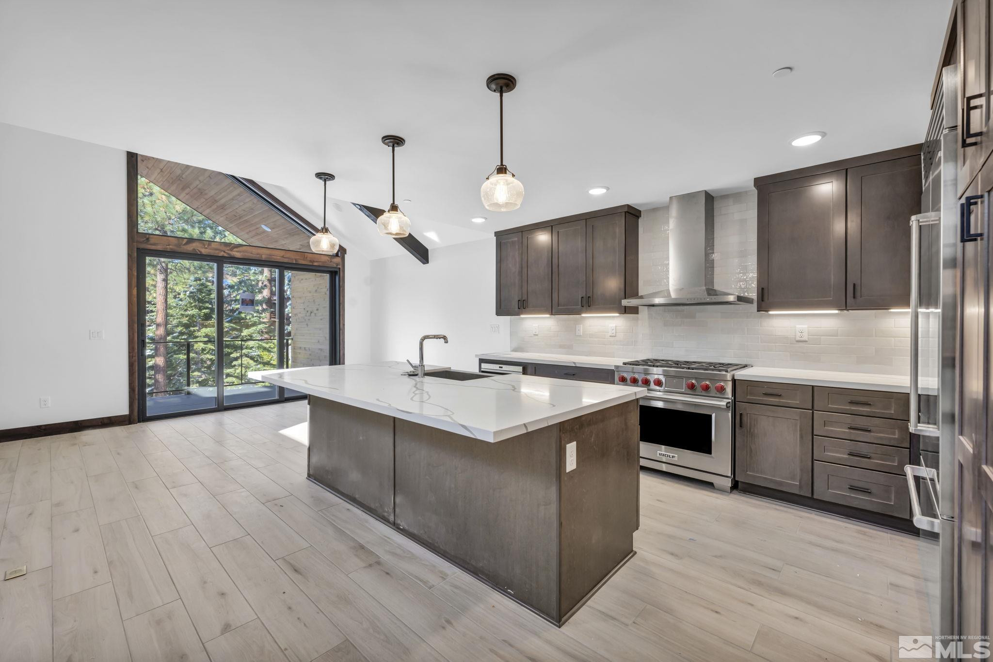 146 Sierra Colina Drive, Unit 34 Stateline, NV 89449 - Photo 12 of 38 a kitchen with stainless steel appliances granite countertop a sink stove and refrigerator