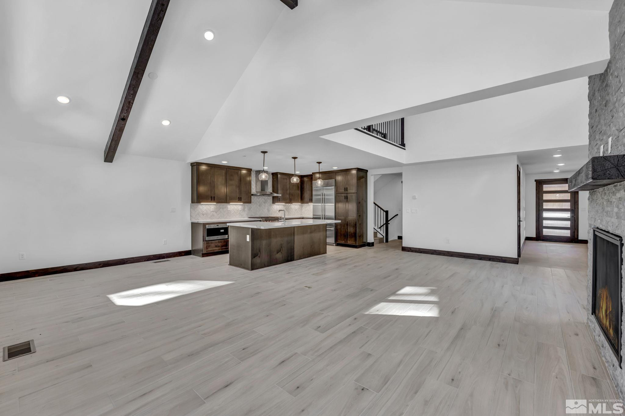 146 Sierra Colina Drive, Unit 34 Stateline, NV 89449 - Photo 17 of 38 a large white kitchen with a cabinetry and kitchen island