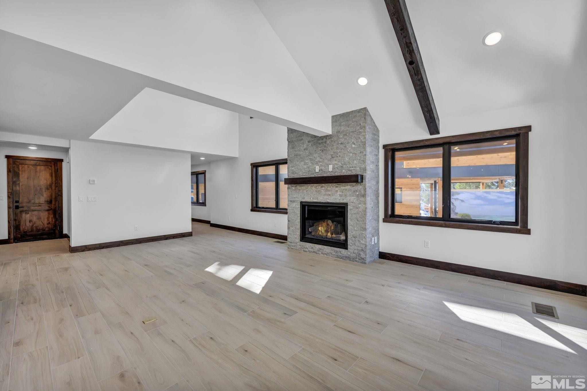 146 Sierra Colina Drive, Unit 34 Stateline, NV 89449 - Photo 18 of 38 a view of empty room with wooden floor and fireplace