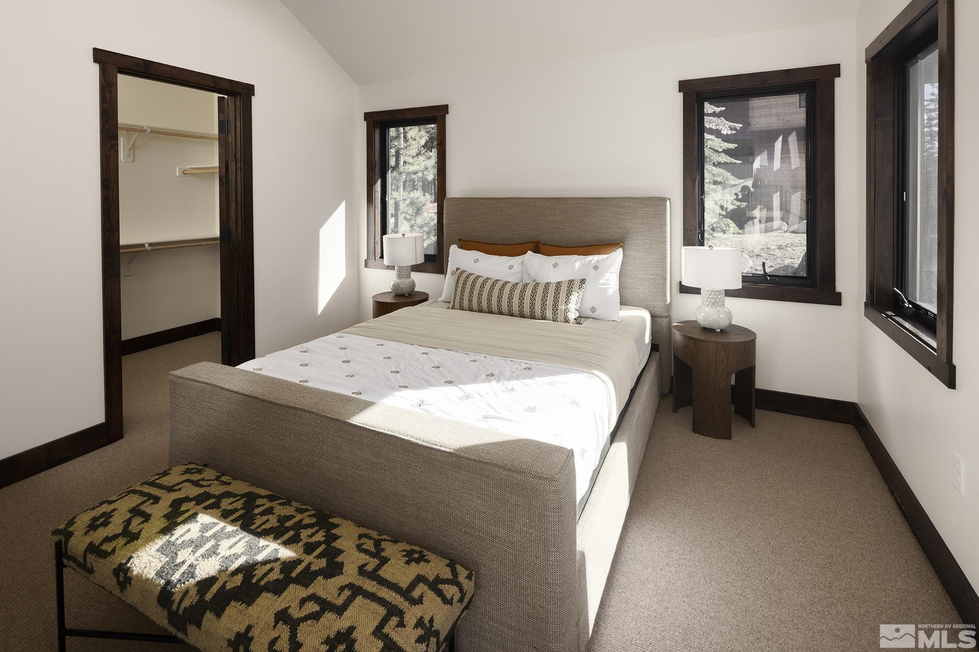 146 Sierra Colina Drive, Unit 34 Stateline, NV 89449 - Photo 24 of 38 a bedroom with a bed and a chandelier