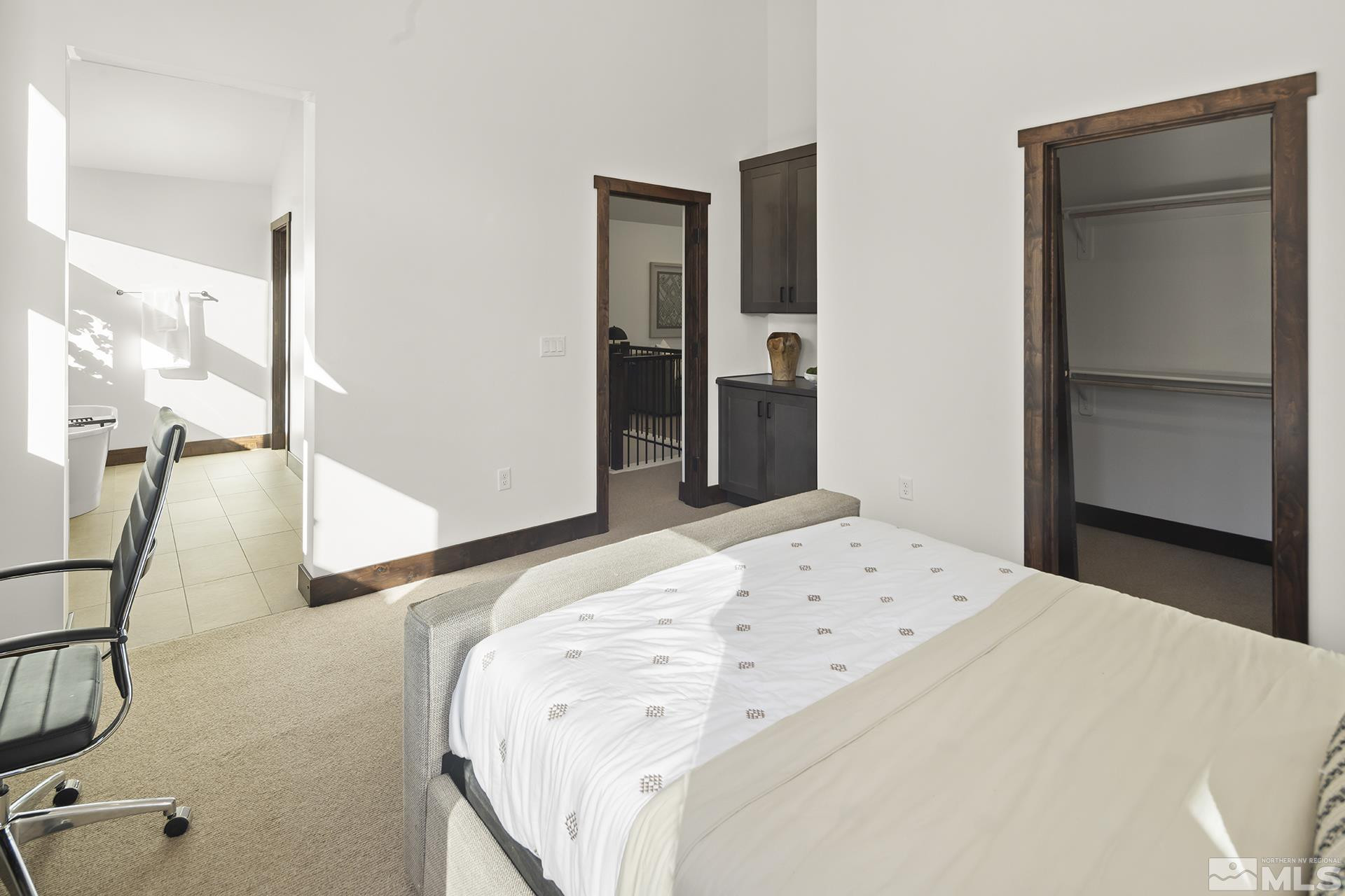 146 Sierra Colina Drive, Unit 34 Stateline, NV 89449 - Photo 25 of 38 a bedroom with a bed and a mirror