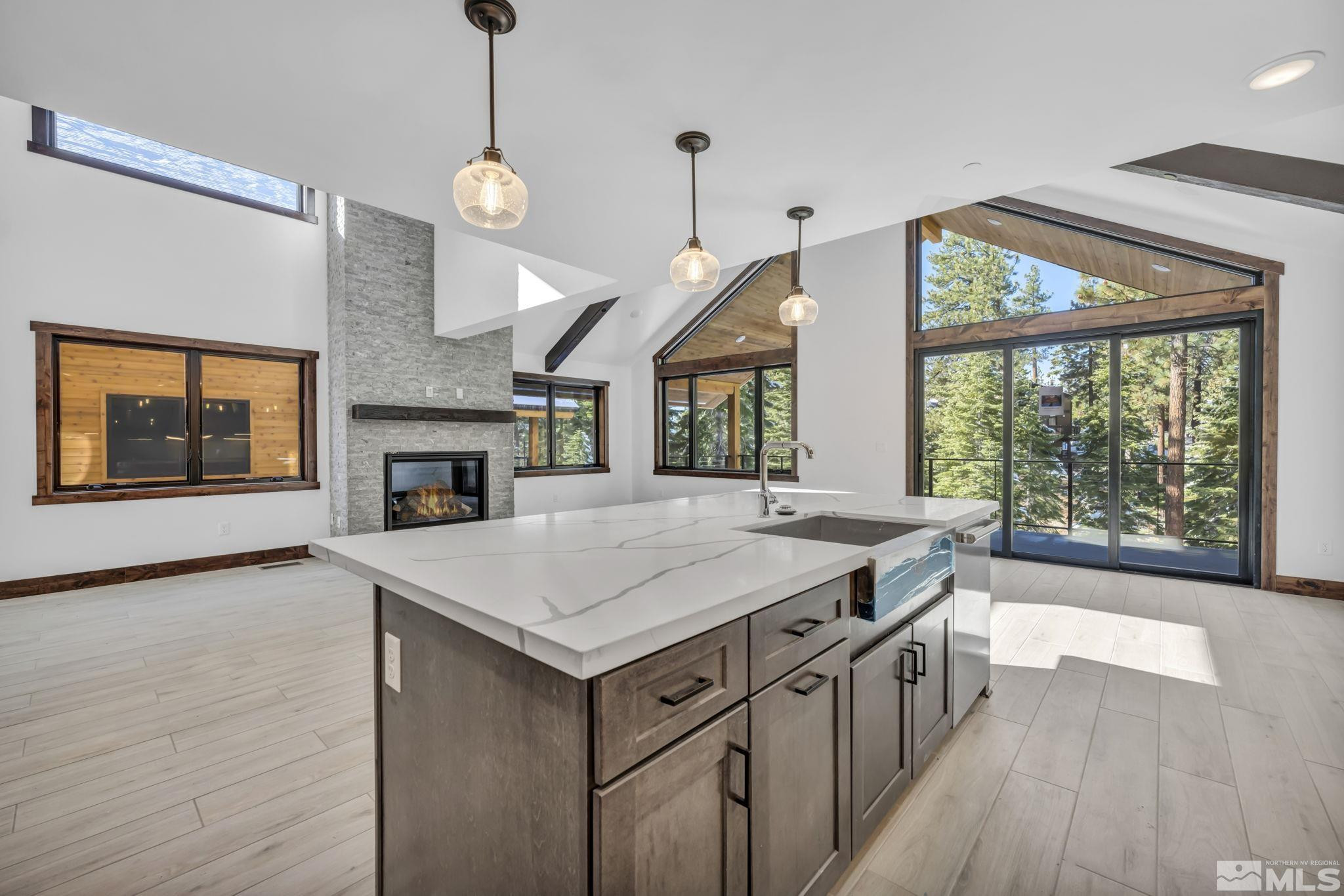 146 Sierra Colina Drive, Unit 34 Stateline, NV 89449 - Photo 3 of 38 a hall with kitchen island a large window and a fireplace