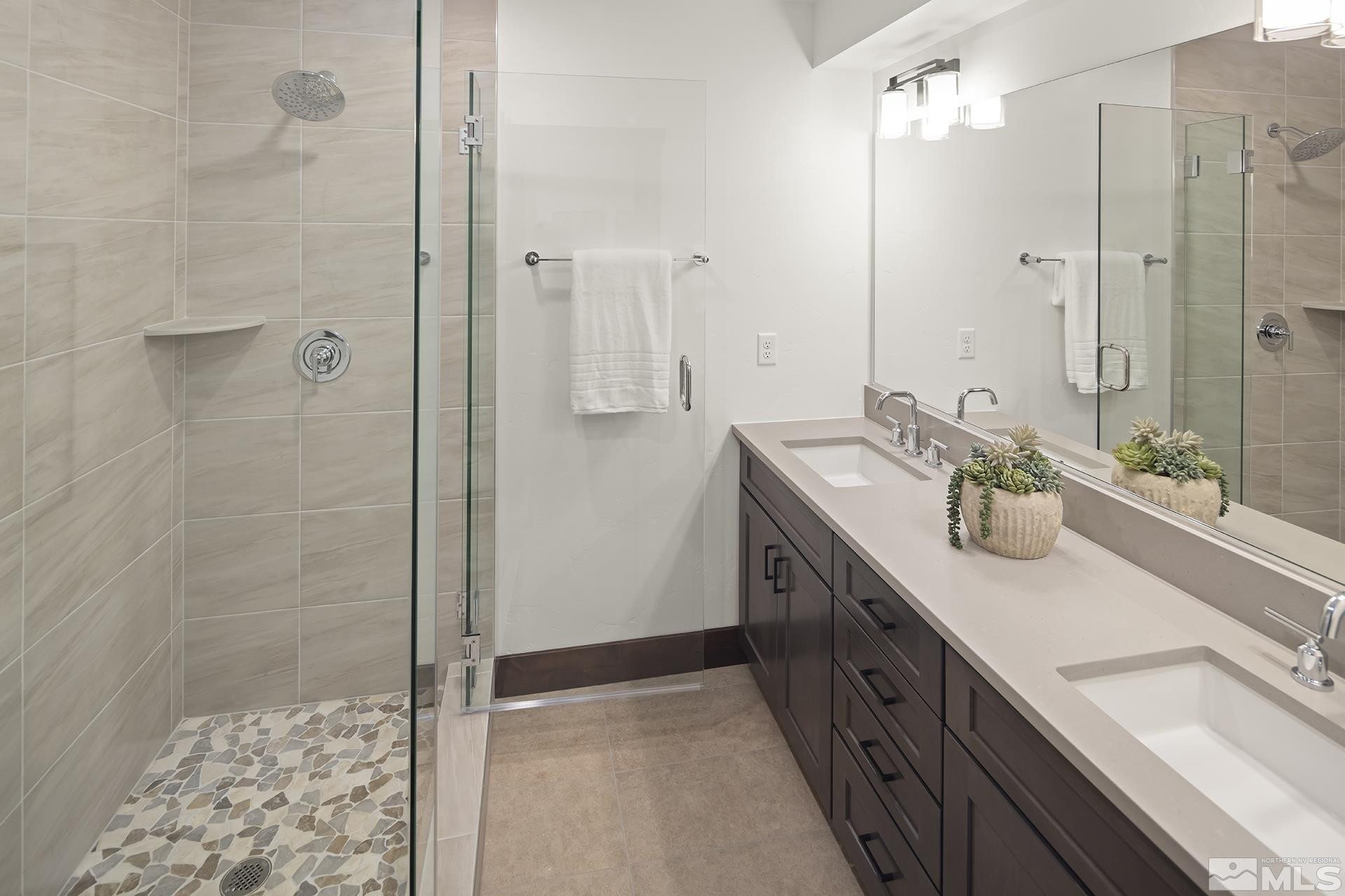 146 Sierra Colina Drive, Unit 34 Stateline, NV 89449 - Photo 32 of 38 a spacious bathroom with a double vanity sink a mirror and shower