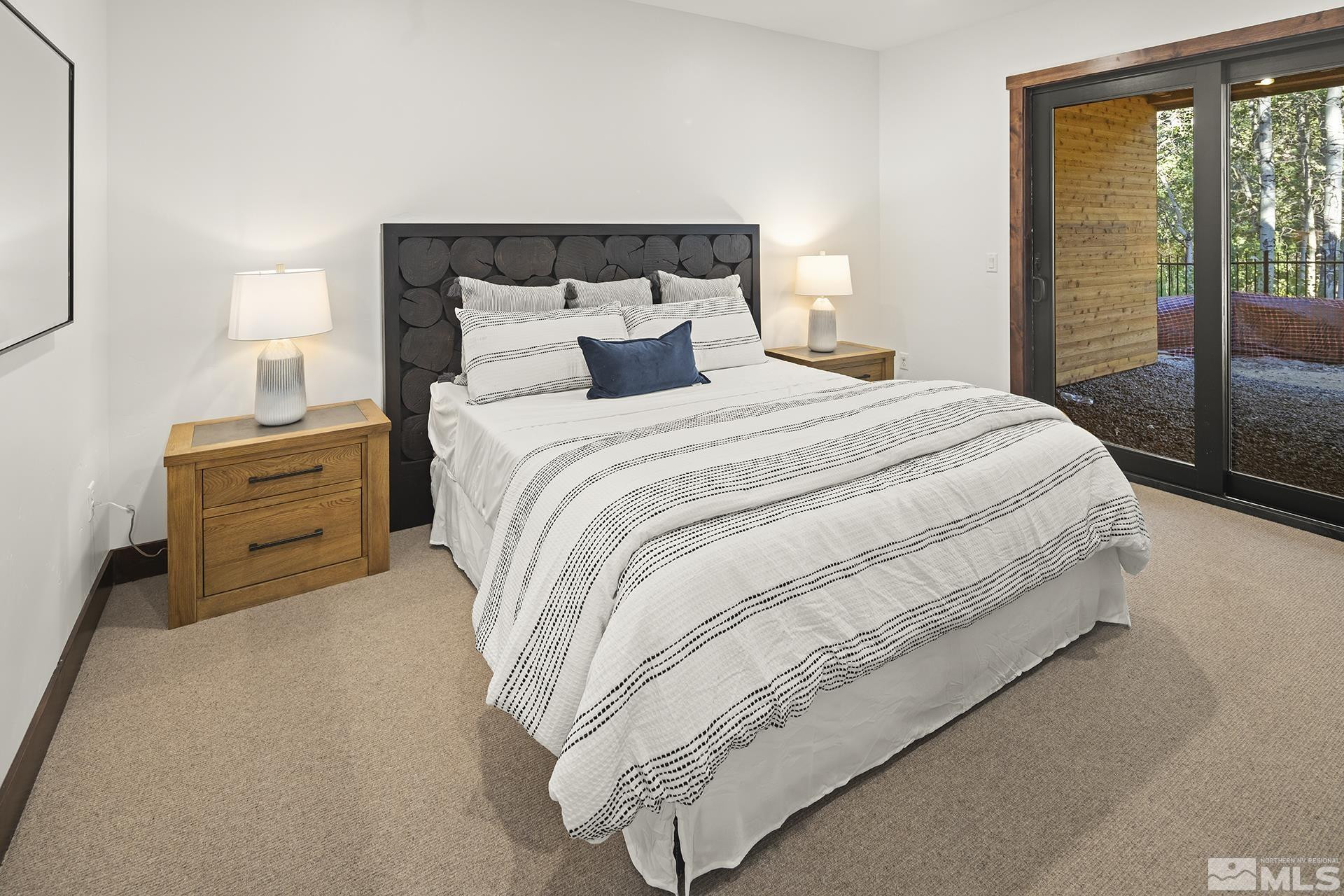 146 Sierra Colina Drive, Unit 34 Stateline, NV 89449 - Photo 33 of 38 a bedroom with a bed and large window