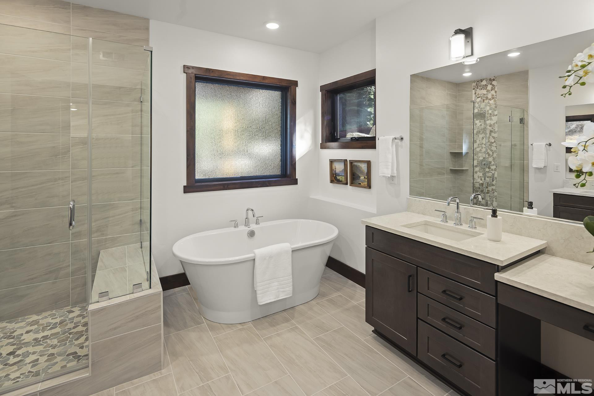 146 Sierra Colina Drive, Unit 34 Stateline, NV 89449 - Photo 35 of 38 a bathroom with a double vanity sink a mirror and a bathtub