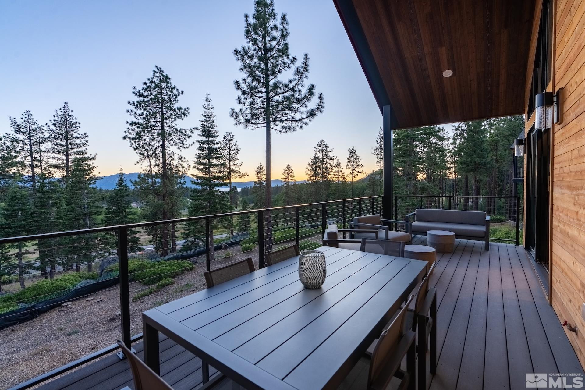 146 Sierra Colina Drive, Unit 34 Stateline, NV 89449 - Photo 36 of 38 a view of a roof deck with table and chairs with wooden floor and fence