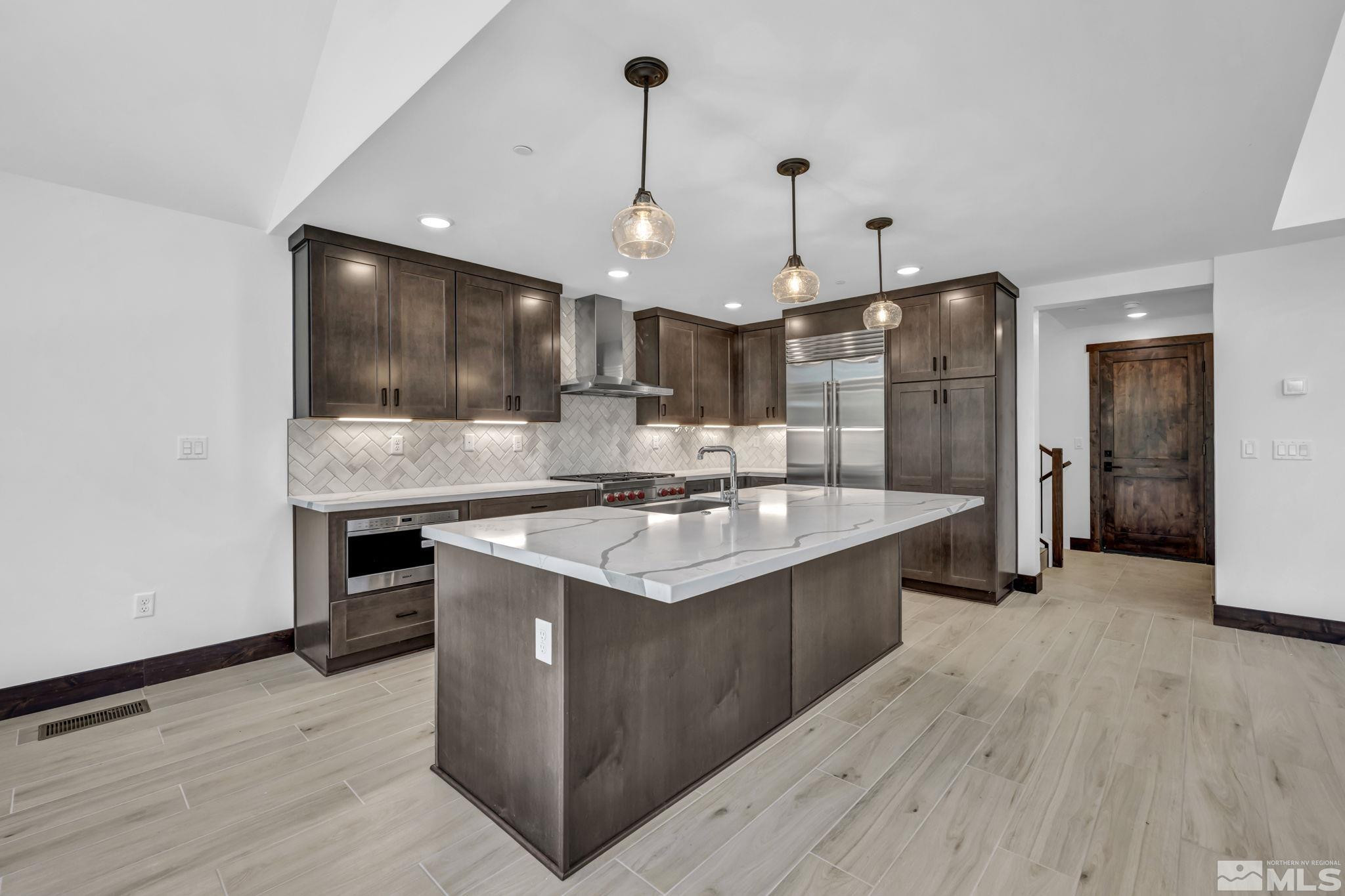 146 Sierra Colina Drive, Unit 34 Stateline, NV 89449 - Photo 6 of 38 a large kitchen with kitchen island a sink stainless steel appliances and cabinets
