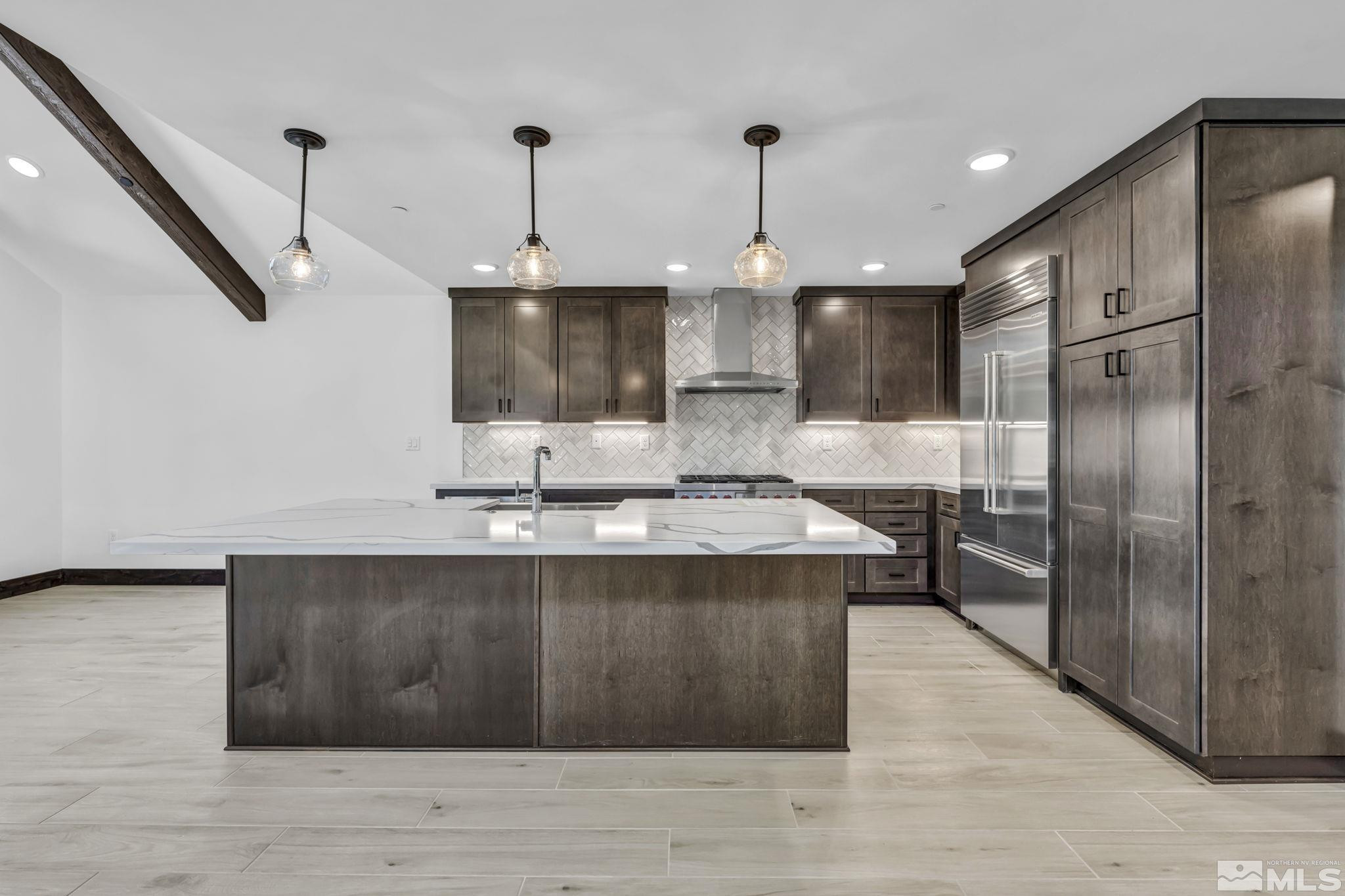 146 Sierra Colina Drive, Unit 34 Stateline, NV 89449 - Photo 7 of 38 a view of a kitchen with a sink stainless steel appliances and cabinets