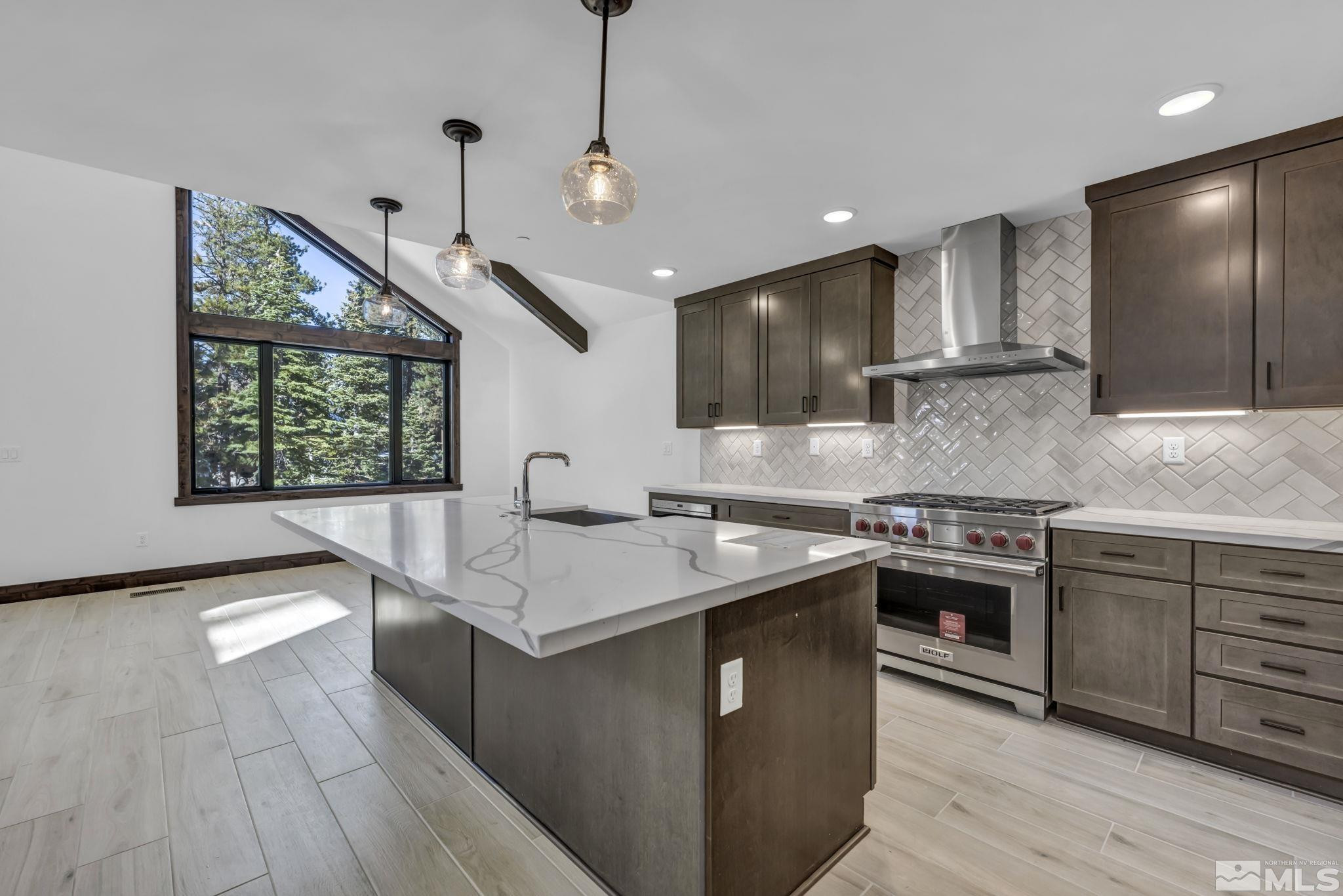 146 Sierra Colina Drive, Unit 34 Stateline, NV 89449 - Photo 8 of 38 a kitchen with stainless steel appliances granite countertop a sink a stove and a wooden floors