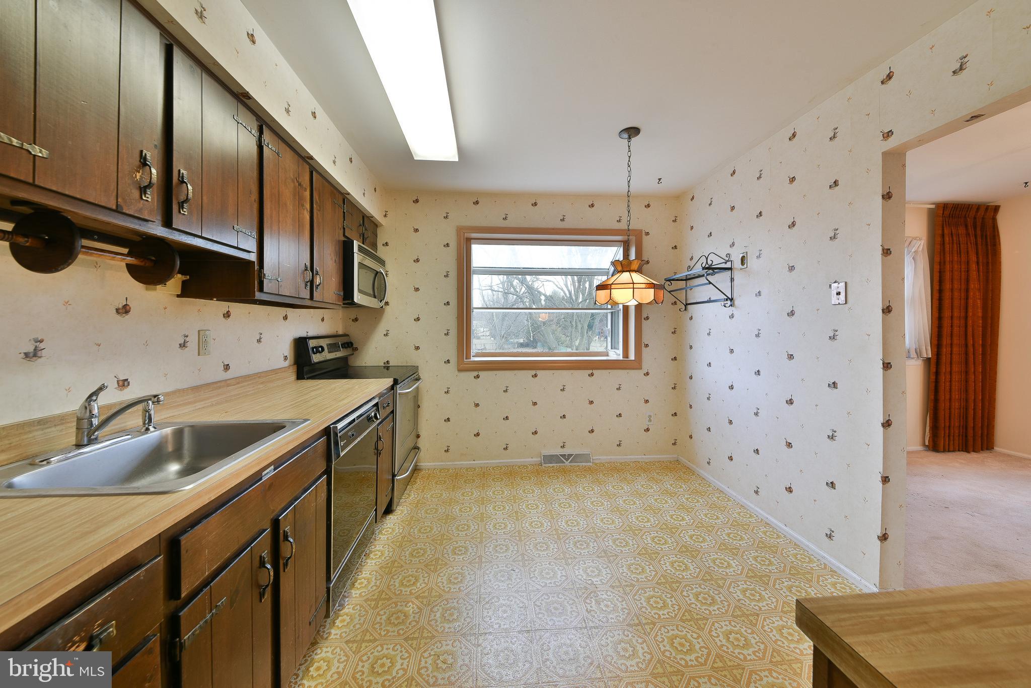 13 Glen Road Lansdale, PA 19446 - Photo 16 of 33 a kitchen with a sink a stove and cabinets