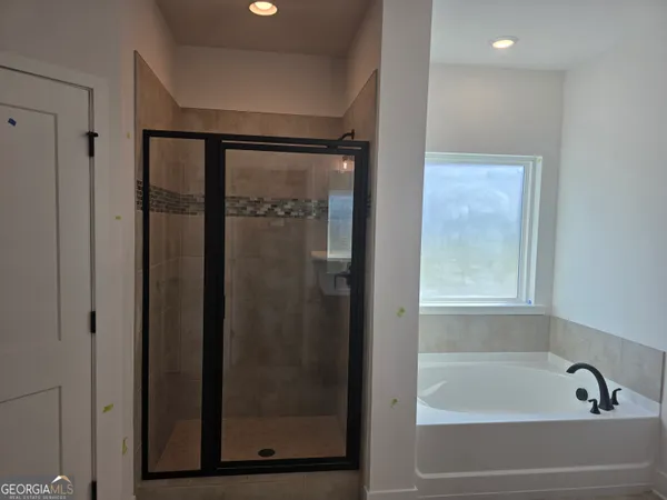 a bathroom with a bathtub and a shower