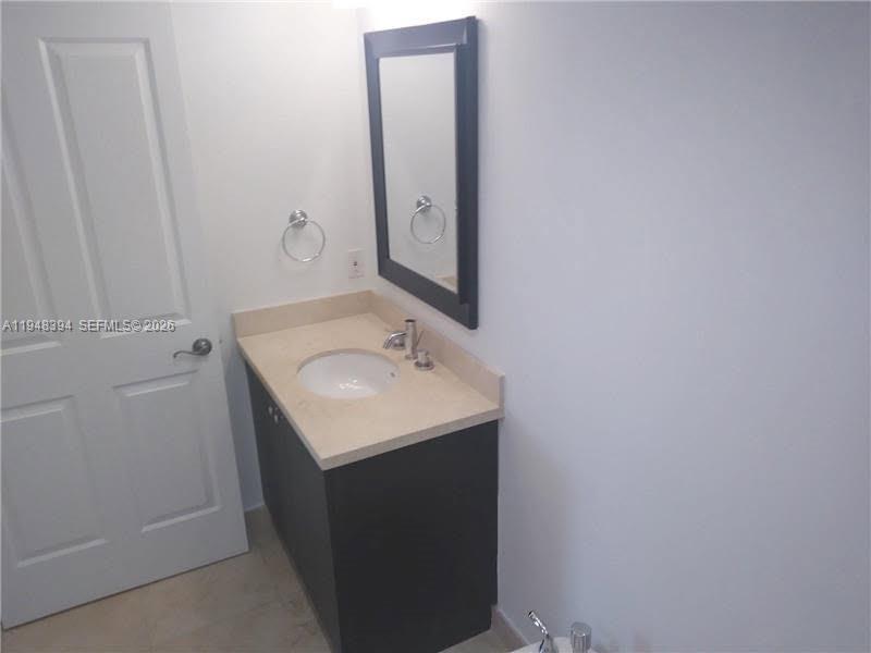 2650 Southwest 37th Avenue, Unit 604 Miami, FL 33134 - Photo 20 of 22 a bathroom with a sink and mirror