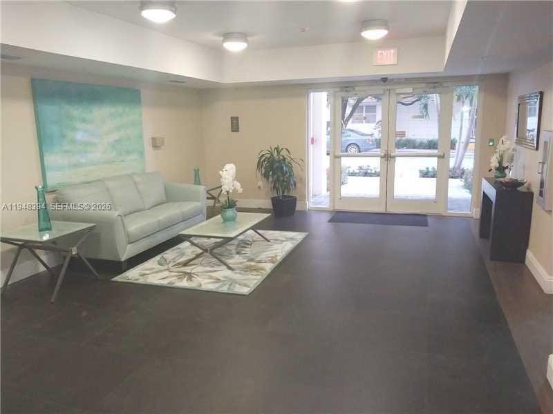 2650 Southwest 37th Avenue, Unit 604 Miami, FL 33134 - Photo 5 of 22 a living room with furniture a flat screen tv and a large window