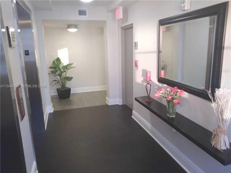 2650 Southwest 37th Avenue, Unit 604 Miami, FL 33134 - Photo 9 of 22 a living room with furniture and flowers