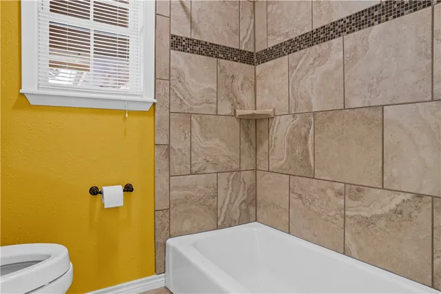 a bathroom with a white bath tub and a shower