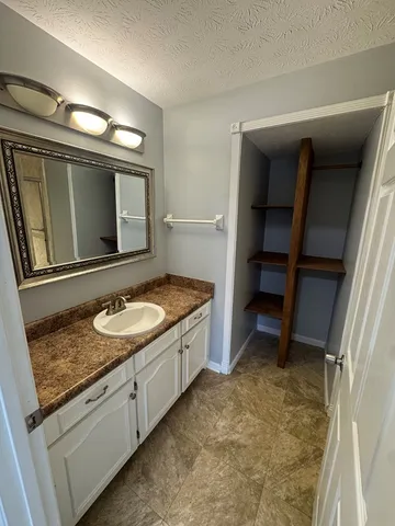 a white toilet sitting next to a bathroom sink