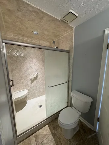 a view of a livingroom with furniture and chandelier fan
