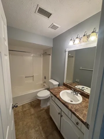 an empty room with a empty space and windows