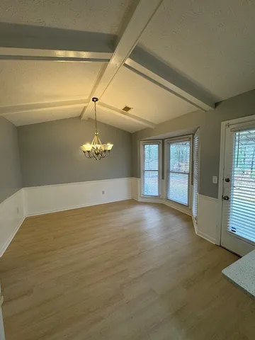 a view of a hallway with windows