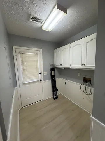 a view of a refrigerator and cabinets
