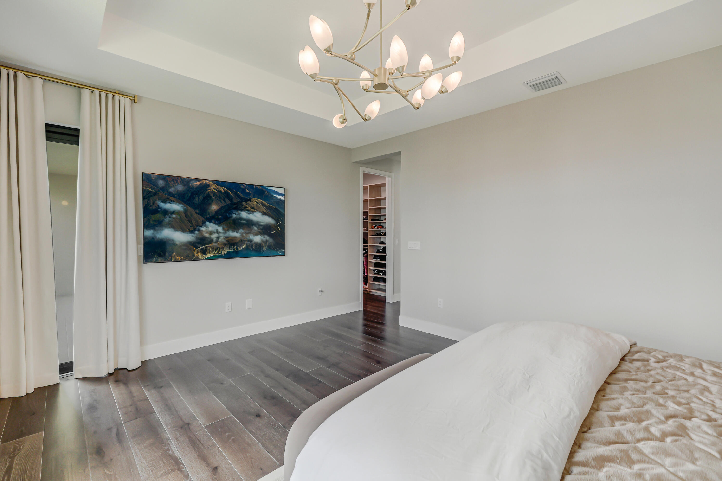 8283 Royal County Down Road Boca Raton, FL 33434 - Photo 40 of 88 a bedroom with a large bed and a chandelier