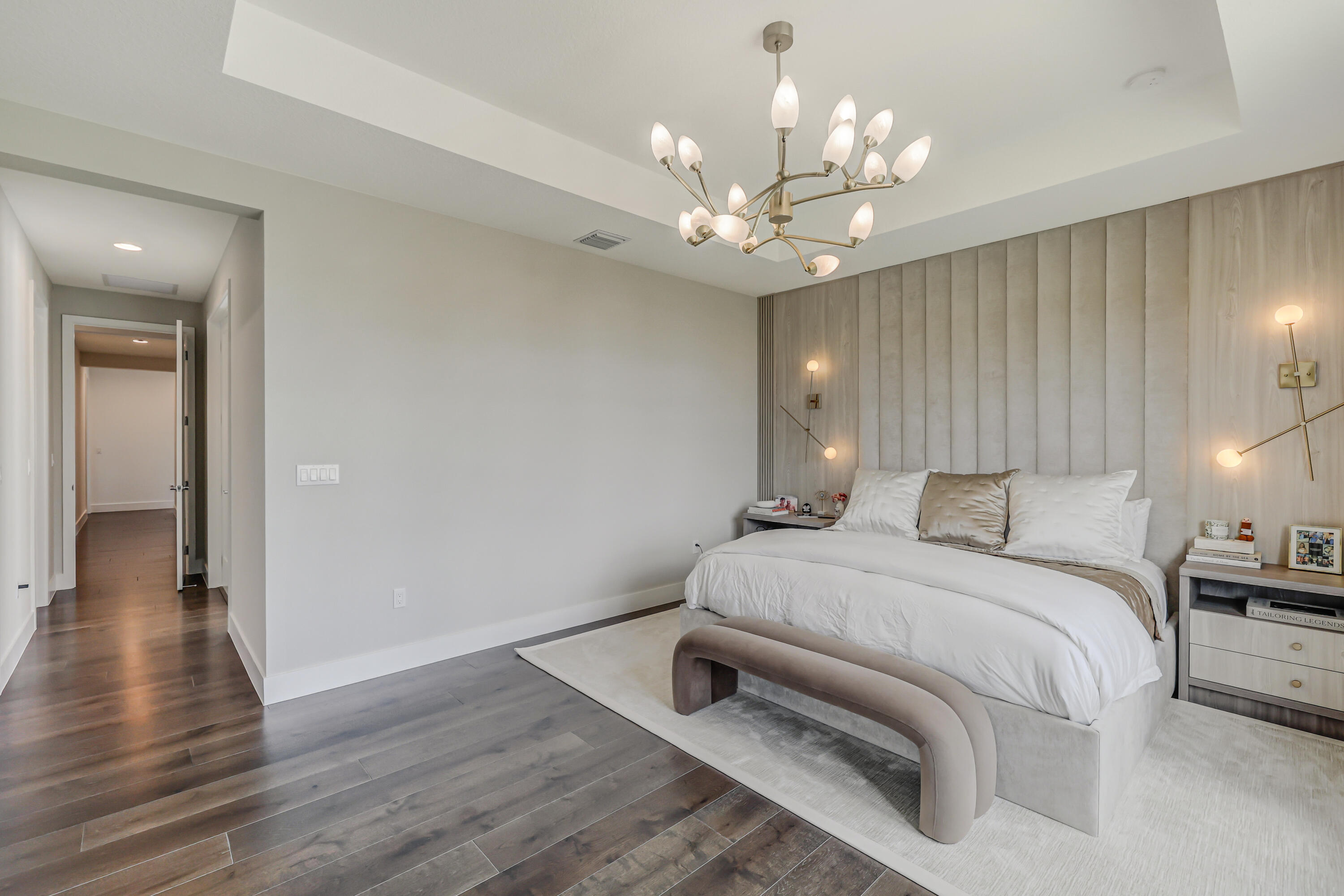 8283 Royal County Down Road Boca Raton, FL 33434 - Photo 41 of 88 a spacious bedroom with a bed and a chandelier