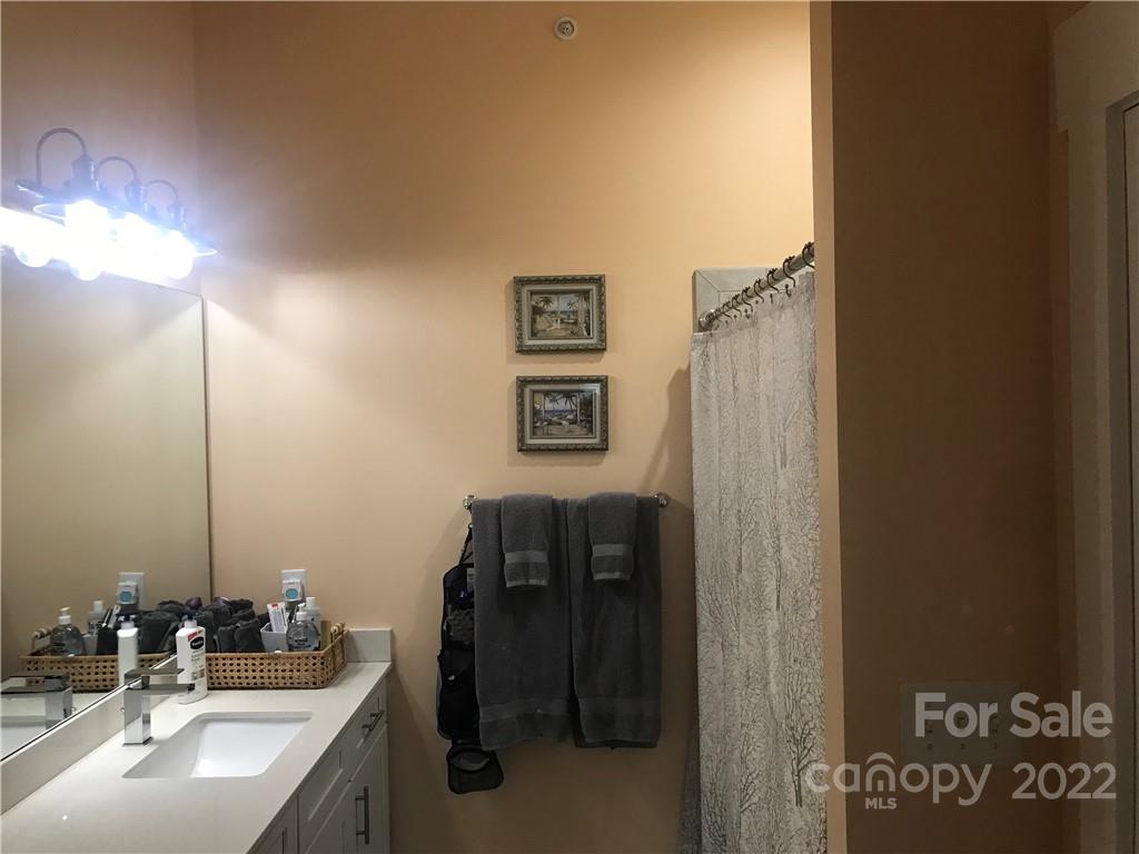 935 McAlway Road, Unit 306 Charlotte, NC 28211 - Photo 12 of 35 a bathroom with a sink and a mirror