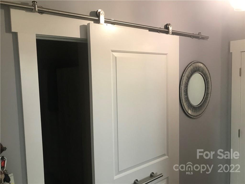 935 McAlway Road, Unit 306 Charlotte, NC 28211 - Photo 13 of 35 a bathroom with a shower a mirror and a sink