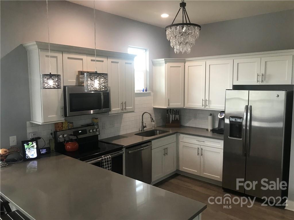 935 McAlway Road, Unit 306 Charlotte, NC 28211 - Photo 16 of 35 a kitchen with stainless steel appliances a sink stove and refrigerator