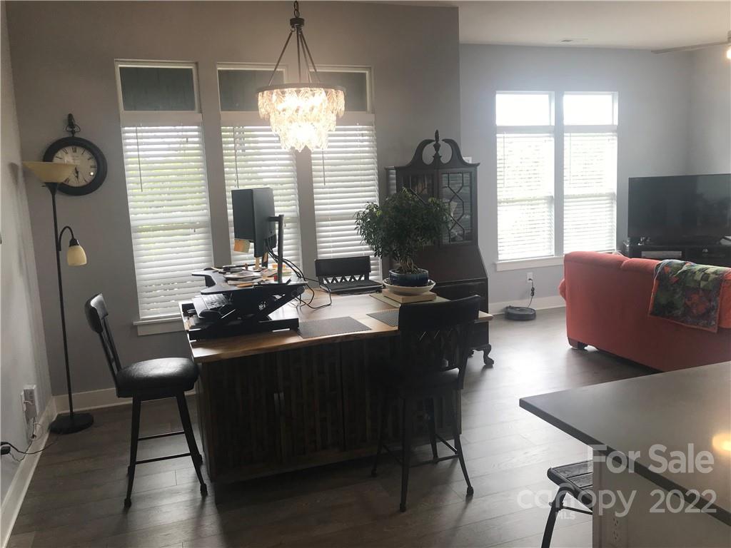 935 McAlway Road, Unit 306 Charlotte, NC 28211 - Photo 17 of 35 a room with furniture a large window and wooden floor