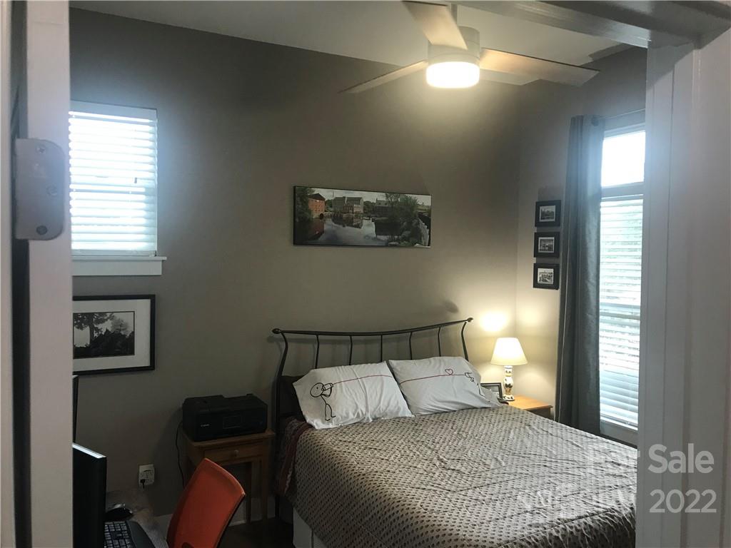 935 McAlway Road, Unit 306 Charlotte, NC 28211 - Photo 31 of 35 a bedroom with a bed and a painting on the wall