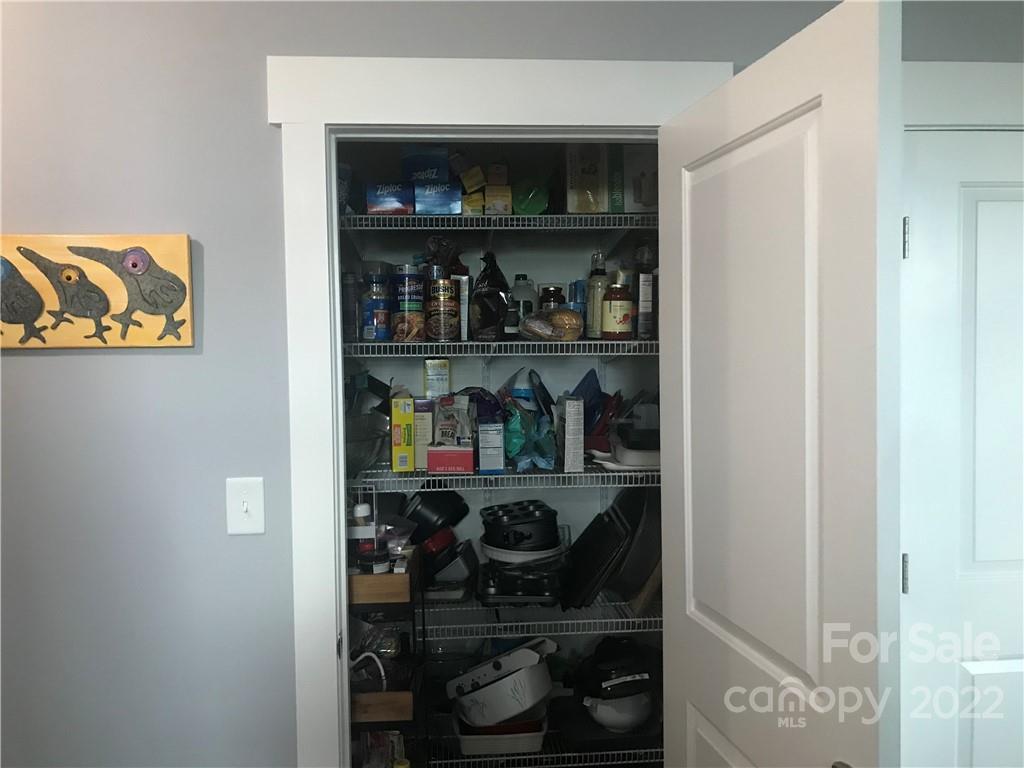 935 McAlway Road, Unit 306 Charlotte, NC 28211 - Photo 33 of 35 a shelf with books and knick knacks on it