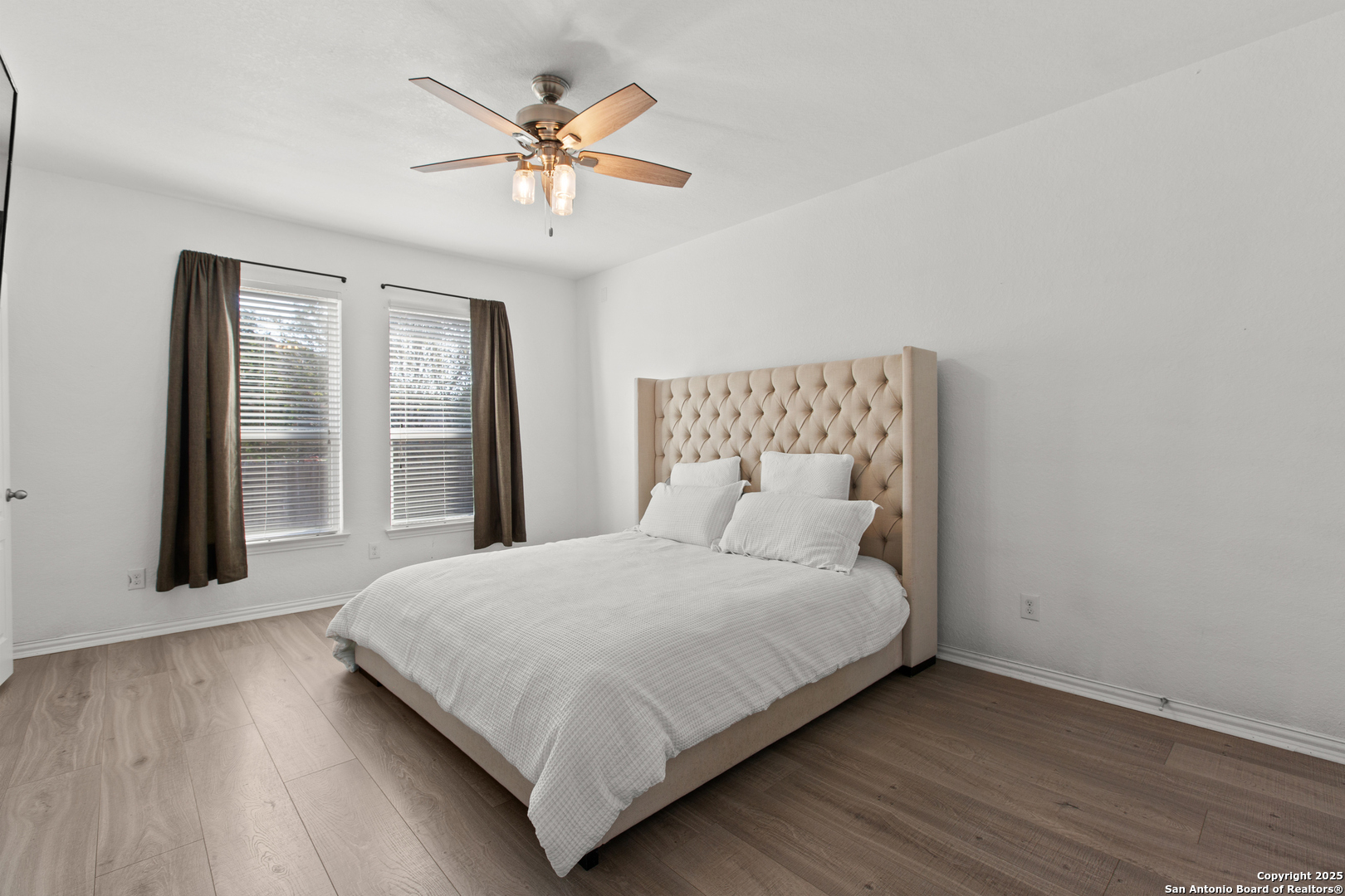 7616 Mission Summit Boerne, TX 78015 - Photo 14 of 22 a bedroom with a large bed chandelier and a window