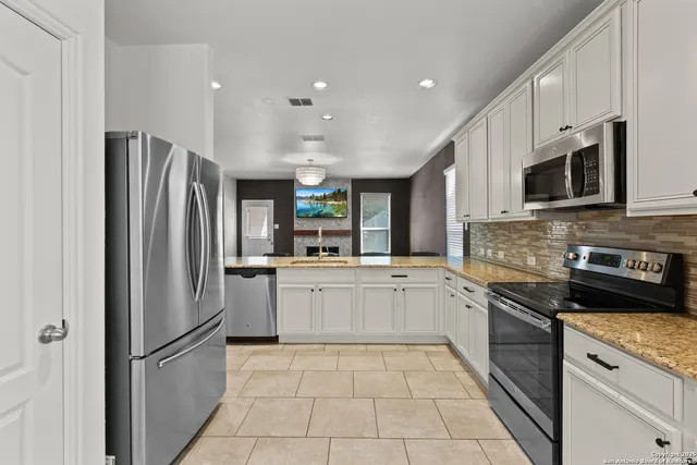 a kitchen with a refrigerator sink and microwave
