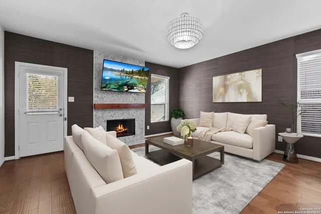 a living room with furniture a fireplace and a window