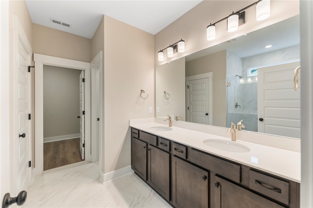 121 Falcon Crest Way Pickens, SC 29671 - Photo 11 of 13 This spacious bathroom features a double vanity and sleek fixtures for comfortable daily routines.