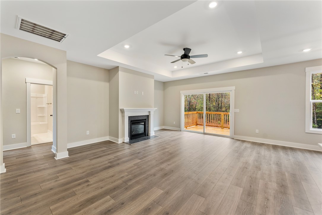 121 Falcon Crest Way Pickens, SC 29671 - Photo 8 of 13 This bright living space features elegant flooring and a cozy fireplace, opening to an outdoor deck.