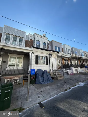 a front view of a building with sitting area
