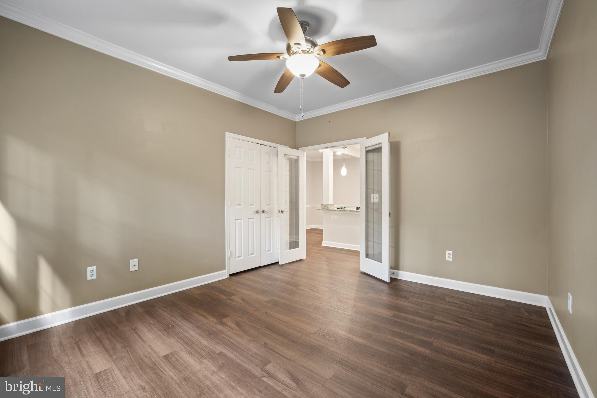 12005 Taliesin Place, Unit 16 Reston, VA 20190 - Photo 11 of 33 wooden floor in an empty room with a window