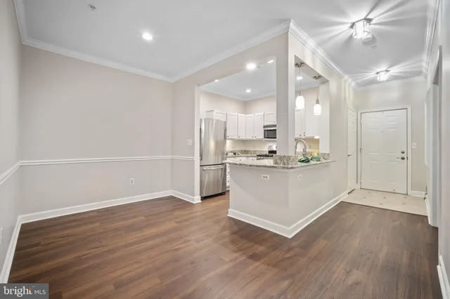 a view of kitchen cabinets and wooden floor