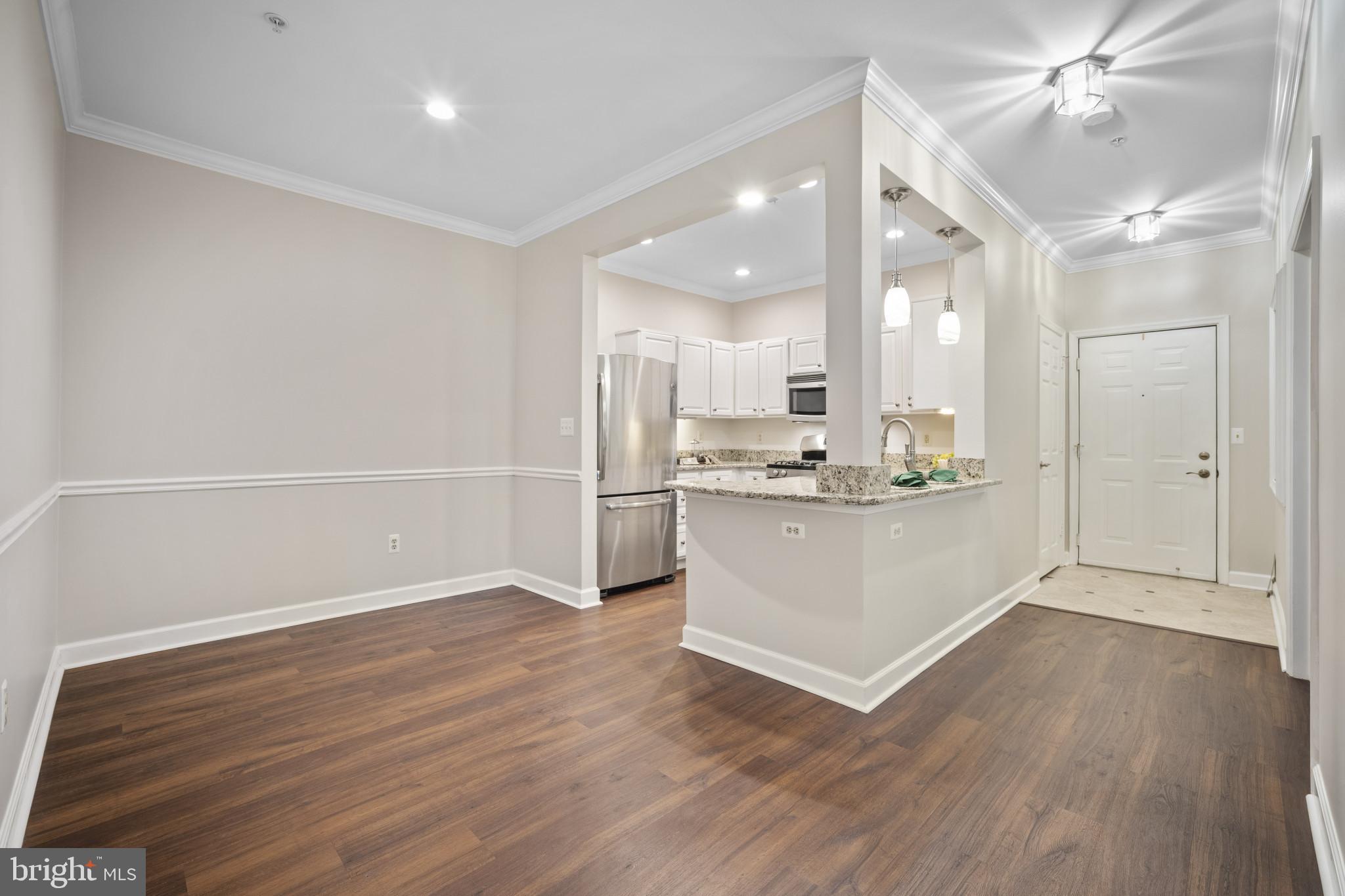 12005 Taliesin Place, Unit 16 Reston, VA 20190 - Photo 14 of 33 a view of kitchen cabinets and wooden floor