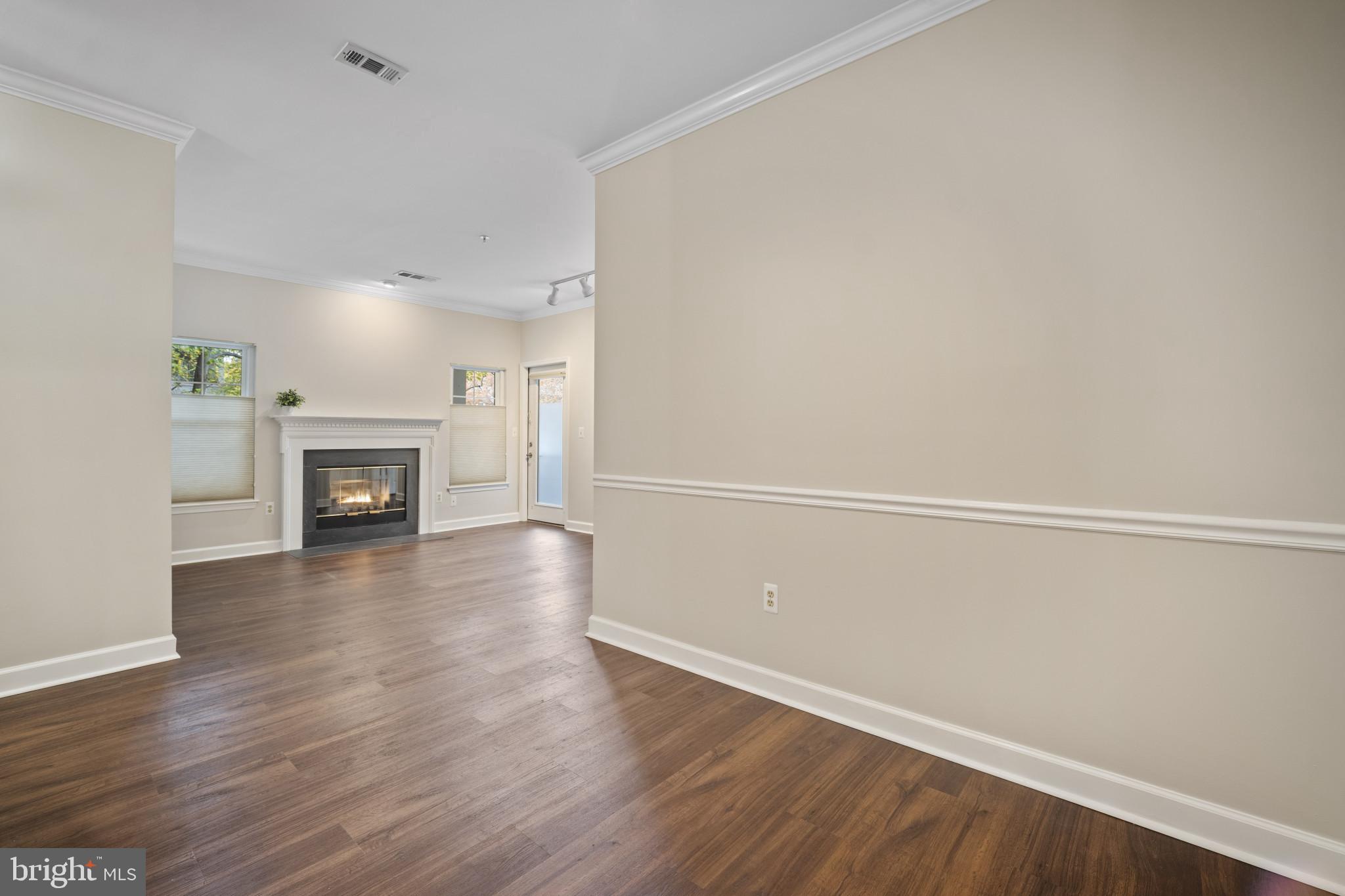 12005 Taliesin Place, Unit 16 Reston, VA 20190 - Photo 15 of 33 a view of a livingroom with wooden floor and a fireplace