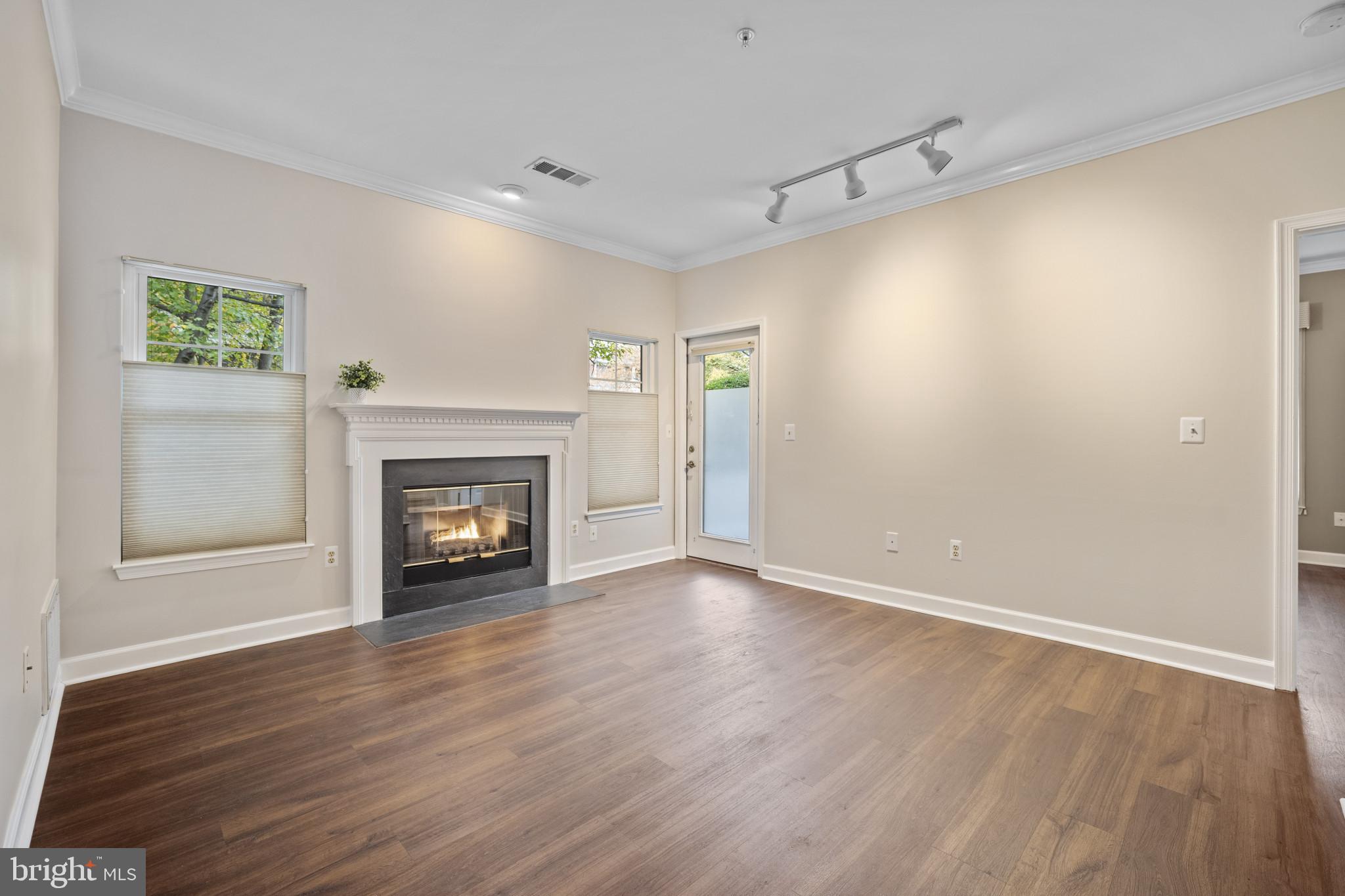 12005 Taliesin Place, Unit 16 Reston, VA 20190 - Photo 17 of 33 a view of an empty room with a fireplace and a window