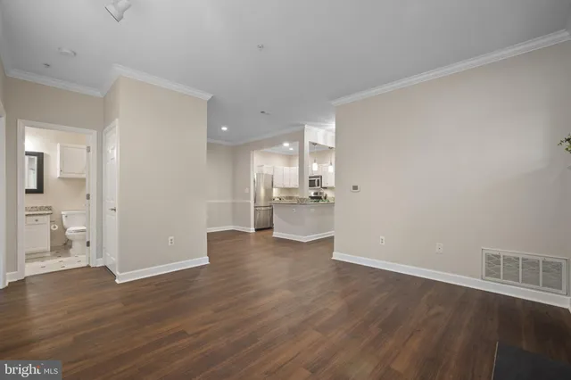 a view of a kitchen with wooden floor and a sink