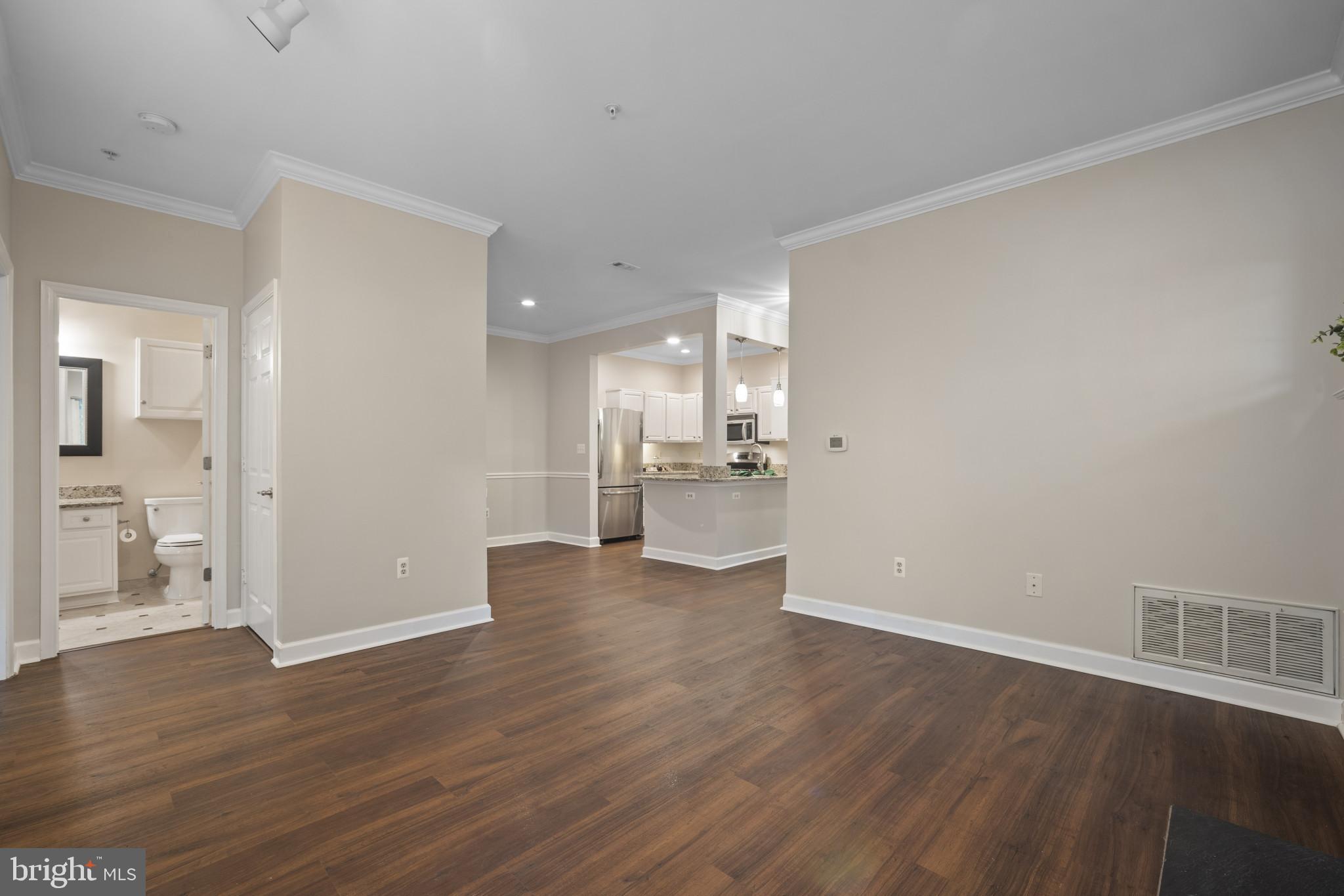 12005 Taliesin Place, Unit 16 Reston, VA 20190 - Photo 19 of 33 a view of a kitchen with wooden floor and a sink