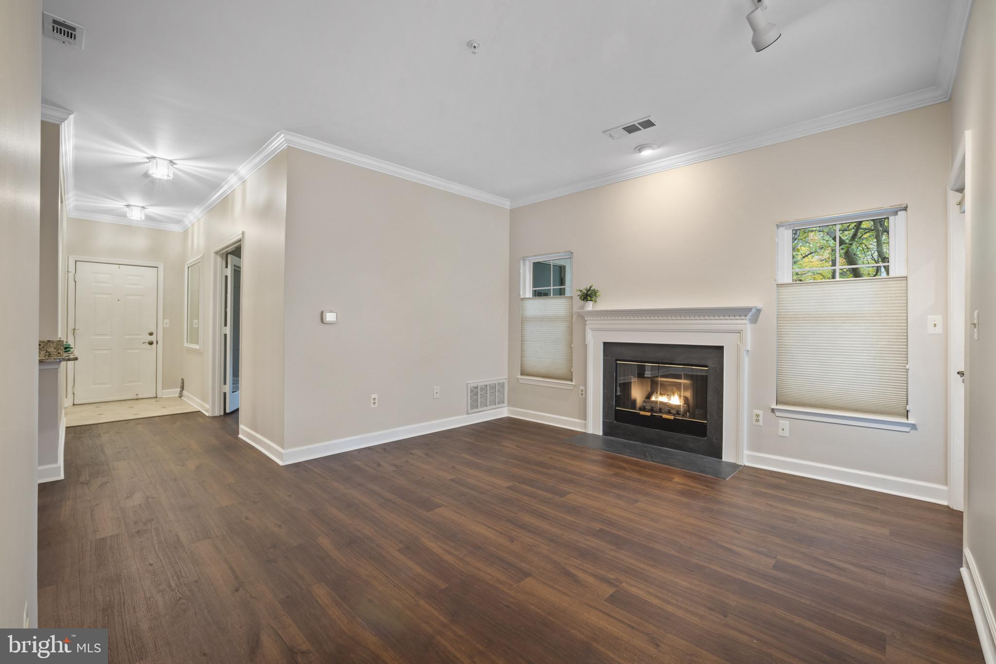 12005 Taliesin Place, Unit 16 Reston, VA 20190 - Photo 20 of 33 a view of an empty room with wooden floor fireplace and a window