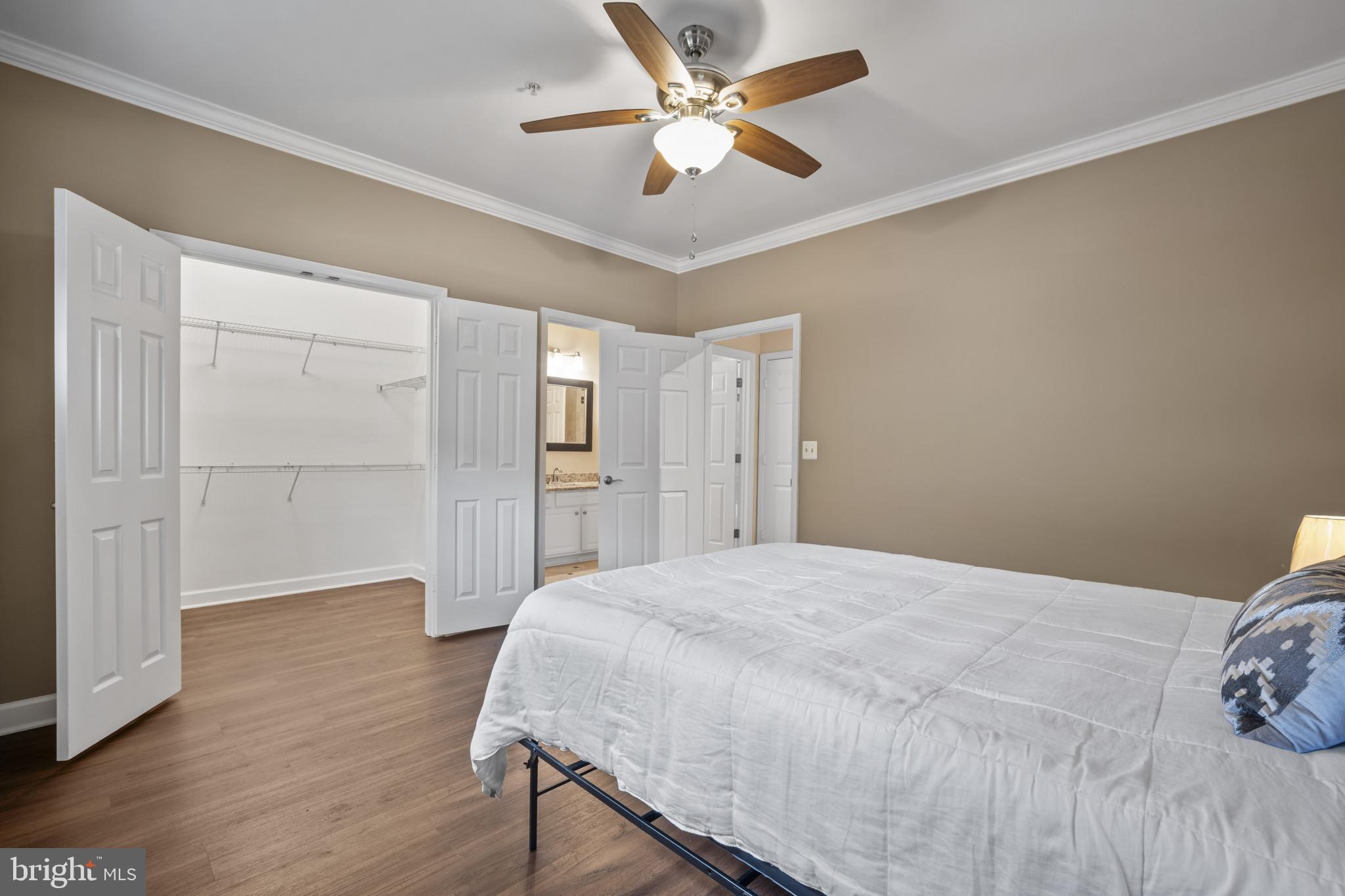 12005 Taliesin Place, Unit 16 Reston, VA 20190 - Photo 24 of 33 a spacious bedroom with a bed and a ceiling fan